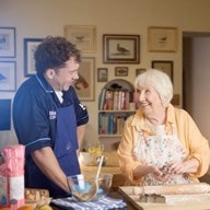 female customer and carer baking in kitchen