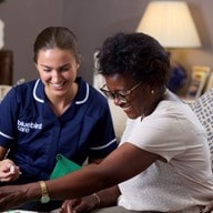 care expert and female customer playing scrabble