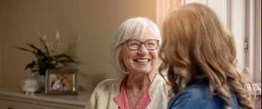 A carer chatting with an elderly lady in the home