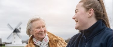 Carer and an elderly lady enjoying time and each others company at the beach
