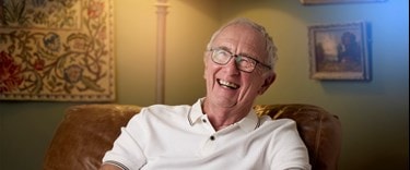 Bluebird Care customer smiling at home having received a postoperative care service