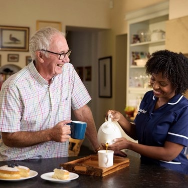 Care Expert and Male Customer Making Tea