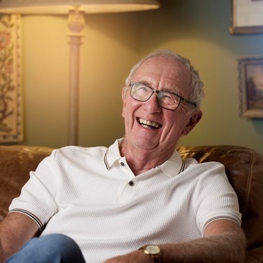happy male customer sitting in a chair
