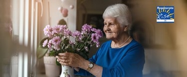Elderly lady with a flower vase