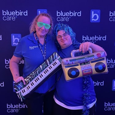 Bluebird Care employee has a photo with a guest at their SEND Nightclub at Wycombe Swan Theatre