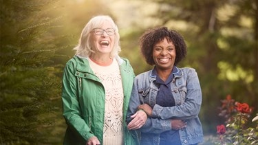 female customer and carer laughing in garden