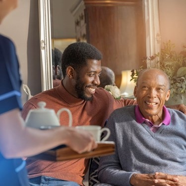 male customer and relative sat on sofa