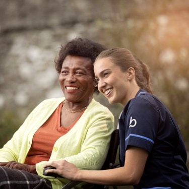 care expert and female customer in wheelchair looking into the distance