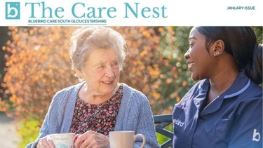 Carer having a cup of tea outside with an elderyl