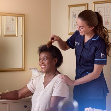 carer combing a female customers hair
