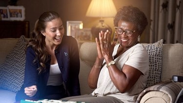 care expert and female customer playing scrabble
