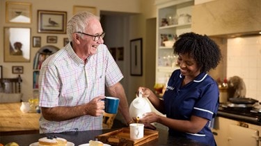 care expert and male customer making tea