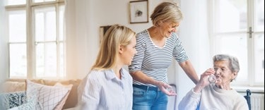Elderly lady chatting with family members at home