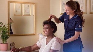 carer combing a female customers hair