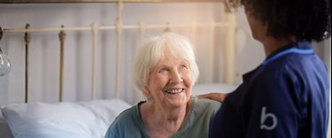 Elderly lady chatting to a carer at home
