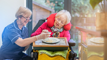 Carer helping customer with eating