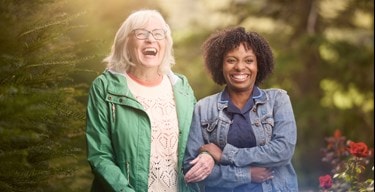 female customer and carer laughing in garden