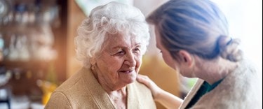 Elderly lady chatting to a family member at home