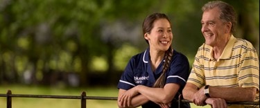 Care Expert and male customer leaning on fence