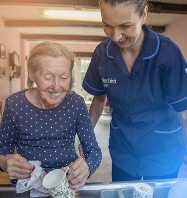 female customer and carer washing up in the sink