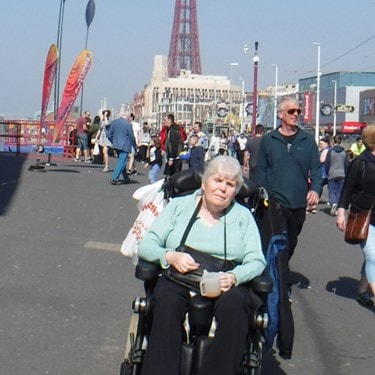 A Bluebird Care customer on holiday in Blackpool with her live-in care assistant