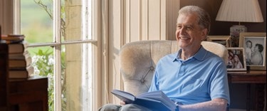Elderly Man reading at home