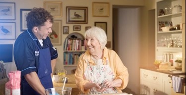 female customer and carer baking in kitchen