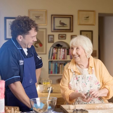 female customer and carer baking in kitchen