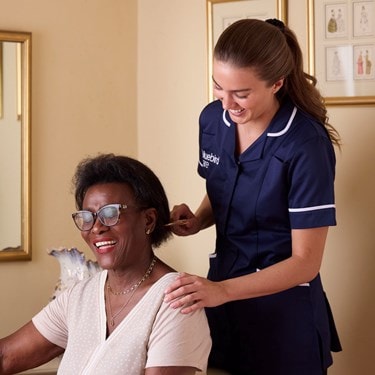 Care Expert brushing female customers hair