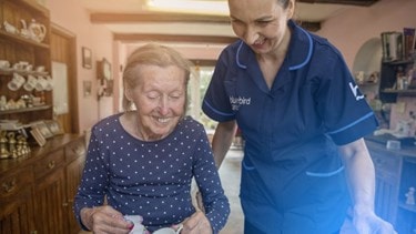 female customer and carer washing up in the sink
