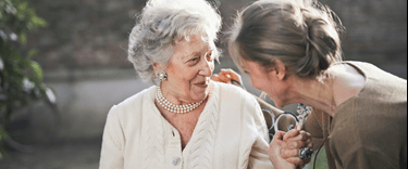 Family member chatting with her elderly mum