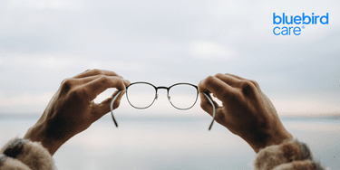 hands holding a pair of glasses