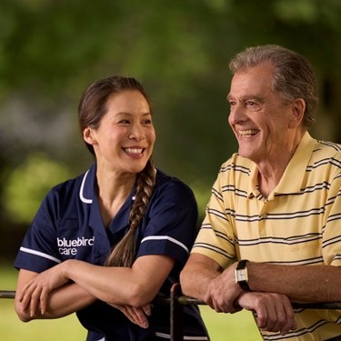 Care Expert and male customer leaning on fence