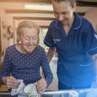 female customer and carer washing up in the sink