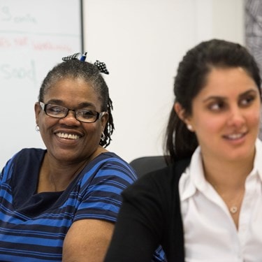 Two smiling female office workers