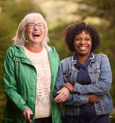 Care Expert and female customer walking outside