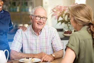 A Bluebird Care Care Expert making a cup of tea with an older gentleman in his kitchen
