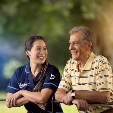 care expert and male customer leaning on fence