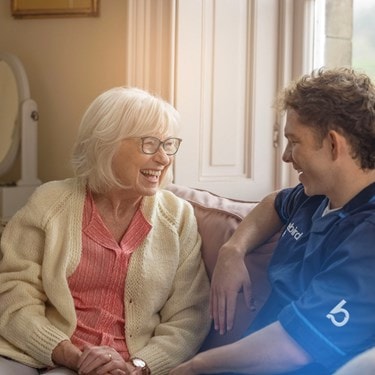 female customer and male carer on sofa