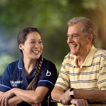 care expert and male customer leaning on fence