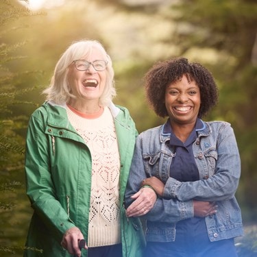 female customer and carer laughing in garden