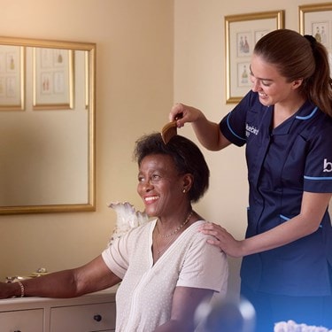 carer combing a female customers hair