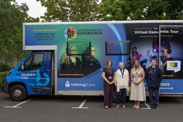 Bluebird Care with Deputy Mayor Cllr Chrissie Holmes at the Virtual Dementia Experience Bus.