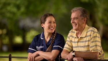 Care Expert and male customer leaning on fence