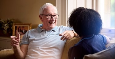 male customer and female carer on sofa