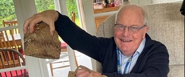 An elderly man at home showing