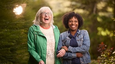 Care Expert and female customer walking outside