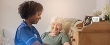 Caregiver looking after an elderly lady at home