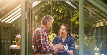 male customer and carer in greenhouse
