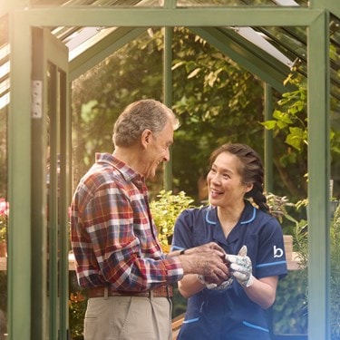 male customer and carer in greenhouse